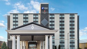A Holiday Inn Express Candlewood Suites hotel entrance with a modern design, featuring a prominent entrance with columns and a covered area. - Holiday Inn Express & Suites Chatham South by IHG (Chatham-Kent)