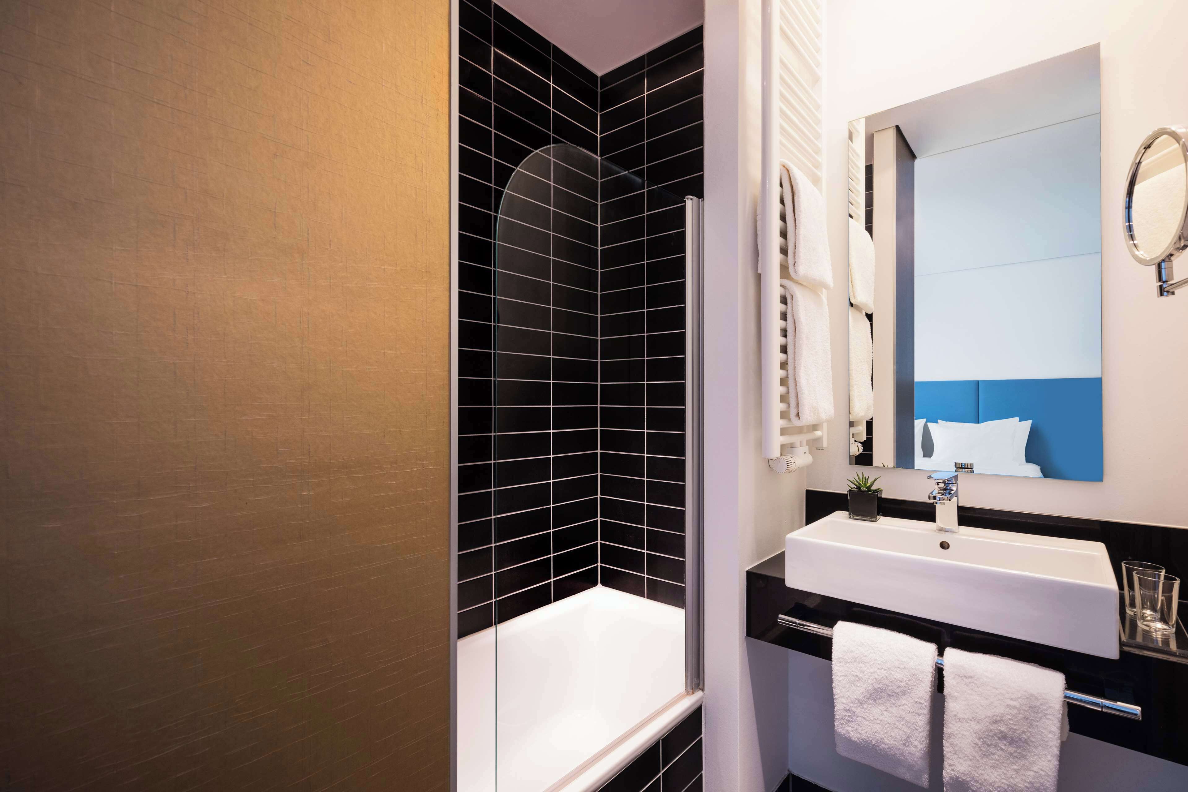 deluxe room, 1 king bed | bathroom | hair dryer, towels, soap, shampoo