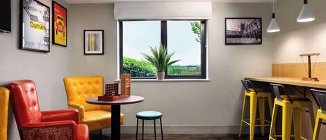 Una habitación moderna con comedor, ventana con vistas y barra.