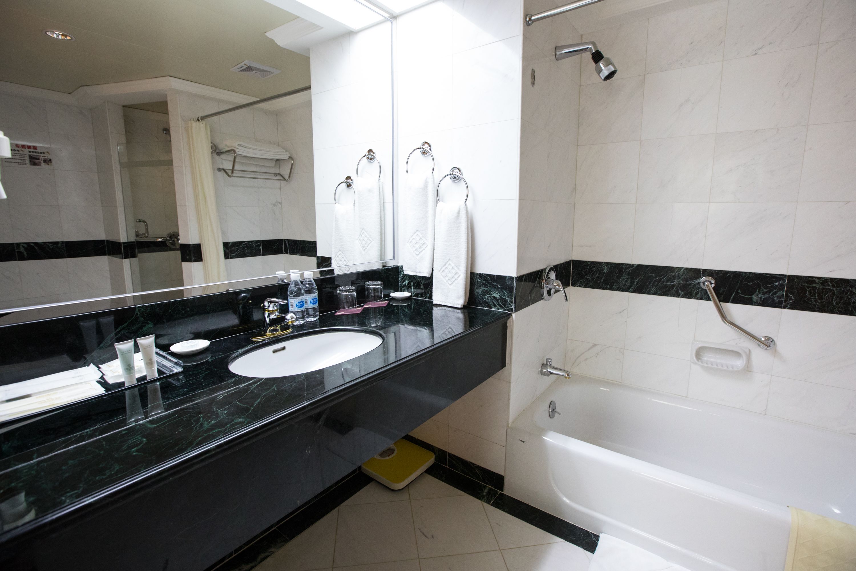 shower, hair dryer, slippers, towels