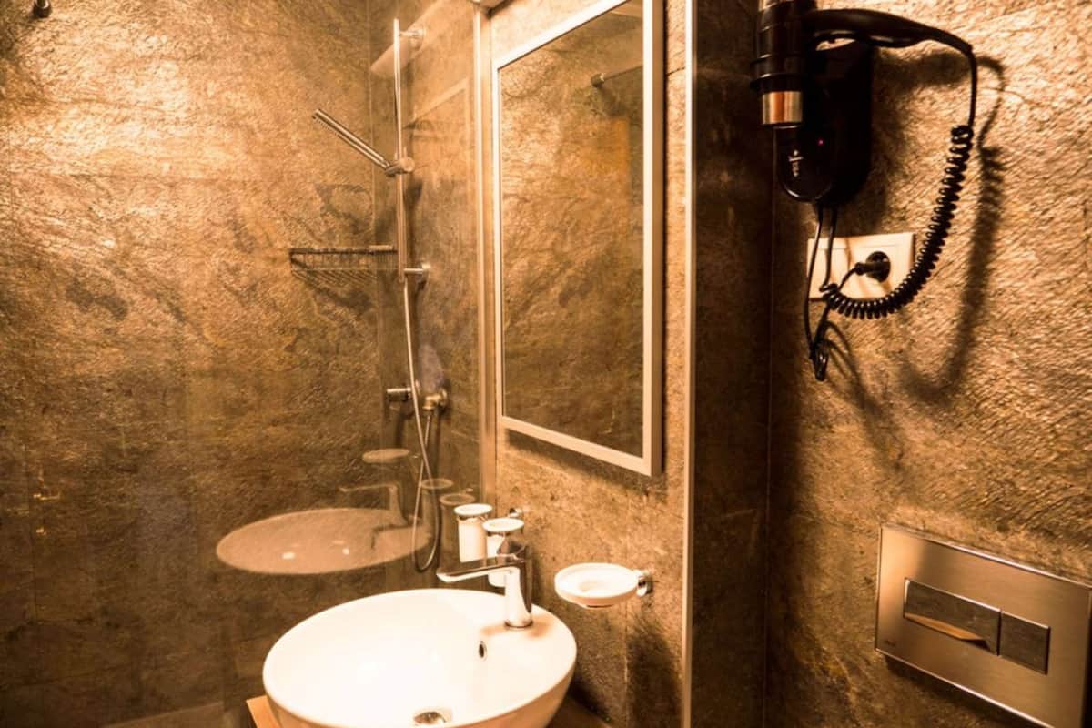 shower, hair dryer, slippers, towels