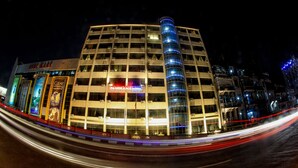 A multi-story hotel with a prominent 'PANDORA HOTEL' sign, featuring a modern design with a curved glass facade and a series of balconies. - Panorama Hotel (Yangon)