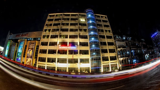 A multi-story hotel with a prominent 'PANDORA HOTEL' sign, featuring a modern design with a curved glass facade and a series of balconies. - Panorama Hotel (Yangon)