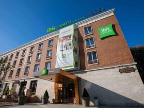 A hotel with a prominent 'ibis Styles' sign, a brick facade, and a large banner advertising 'ZAMBESTE.' - Dunarea Hotel (Galati)