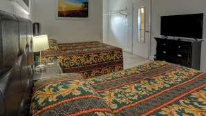 A hotel room with two beds, a TV, a dresser, and a painting on the wall. - Beach and Town Motel (Hollywood)