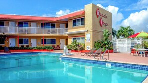 A hotel with a swimming pool, a two-story building, and a sign that reads "Beach Town". - Beach and Town Motel (Hollywood)