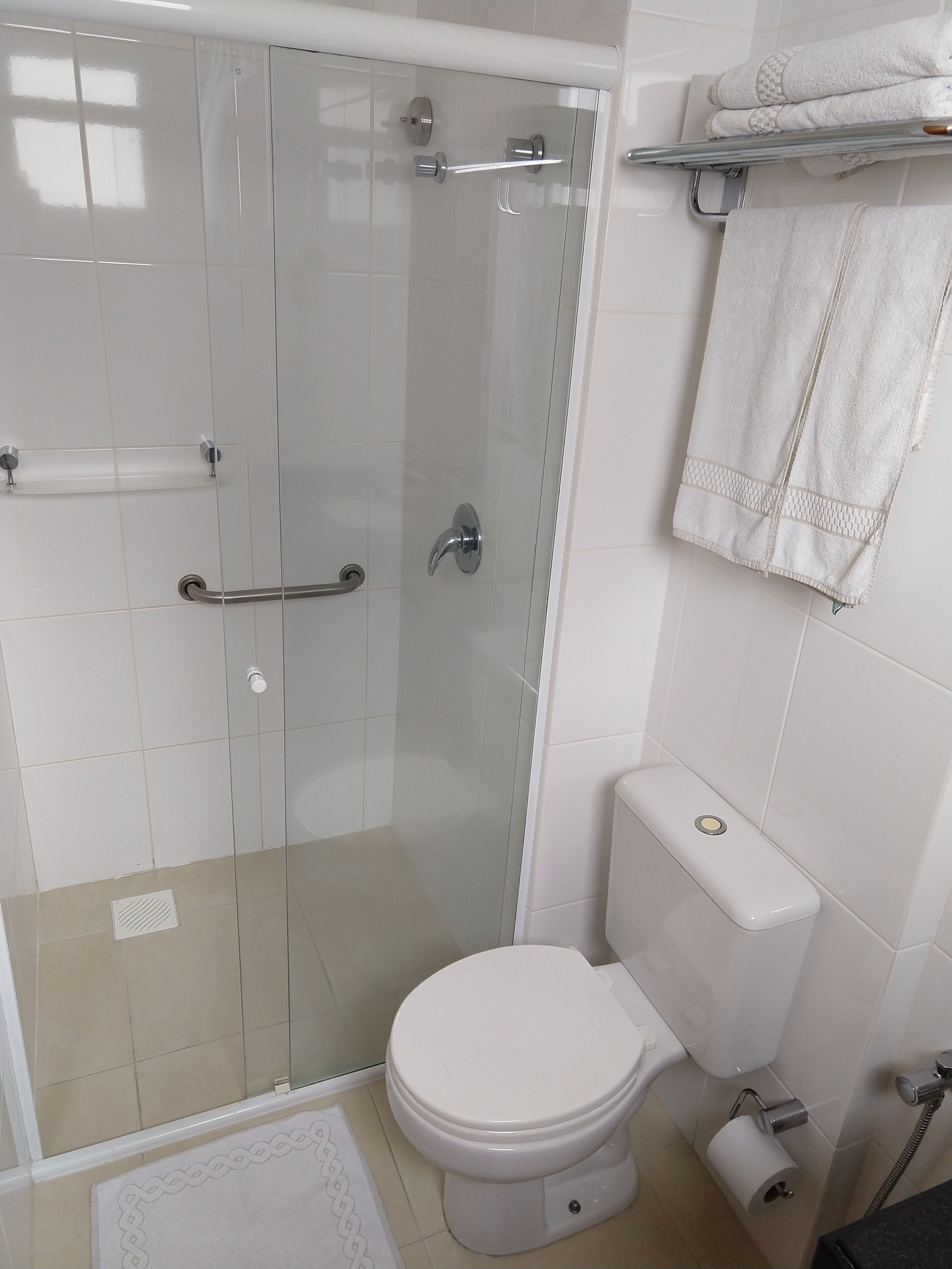 shower, rainfall showerhead, hair dryer, towels