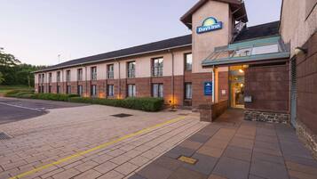 Welcome to Days Inn, featuring a simple, functional design with a covered entrance.