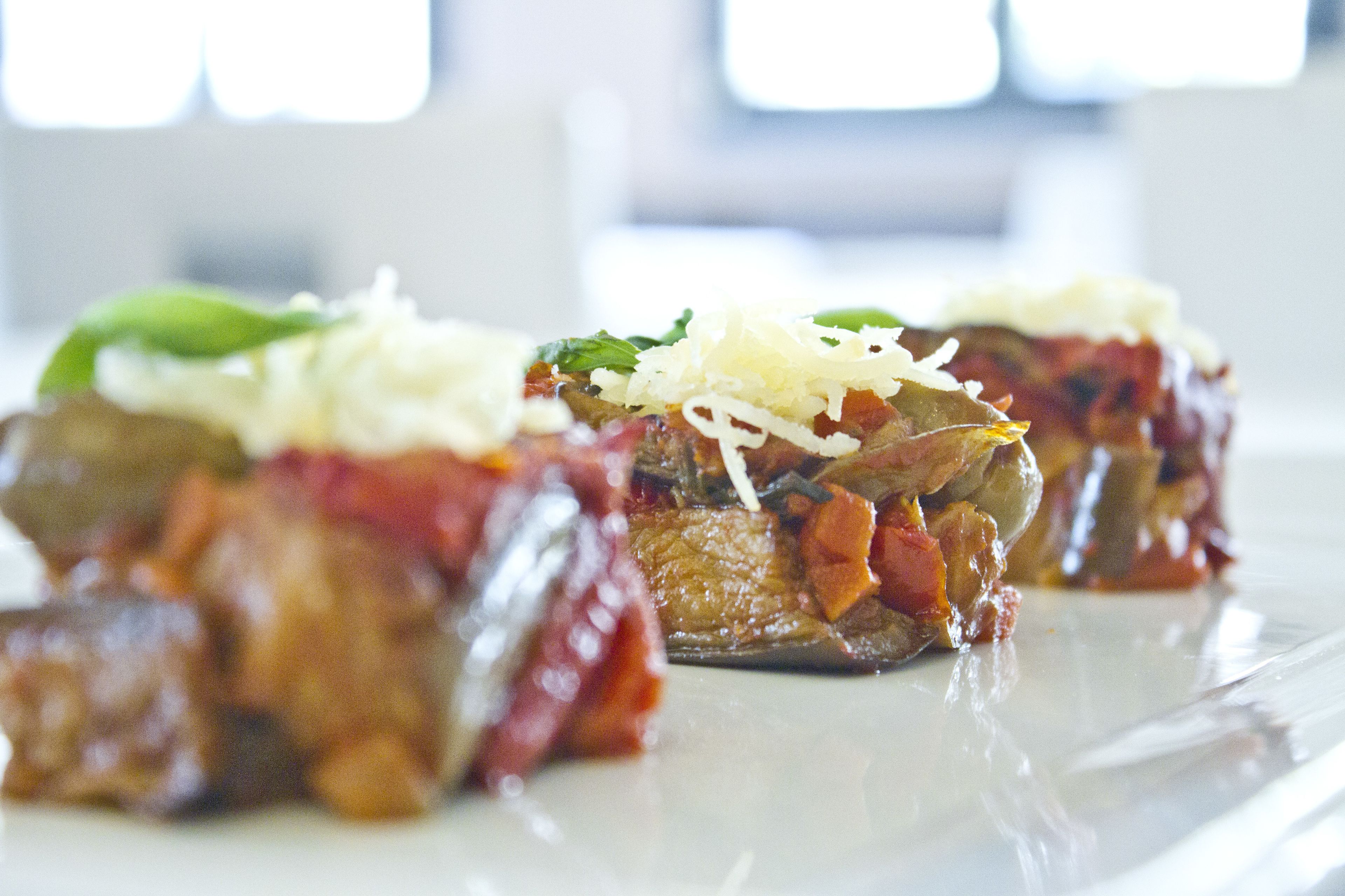 A plate of stuffed vegetables with cheese and herbs.