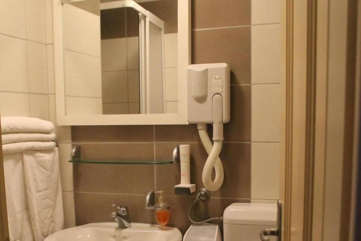 Shower, hair dryer, slippers, towels