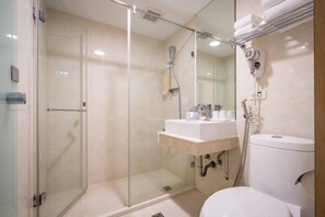 A modern bathroom with a glass-enclosed shower, a white sink, and a toilet. - Hotel B (Taipei)