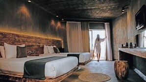 A modern hotel room with two beds, a wooden headboard, a round wooden stool, and a large window with curtains. - Meraki Resort - Adults Only - All inclusive (Hurghada)