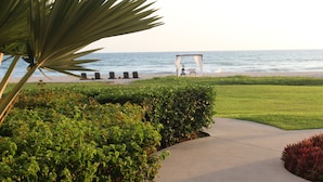 A beachfront property with a pathway leading to a gazebo by the sea. - Las Villas Hotel & Golf by Estrella del Mar (Mazatlán)