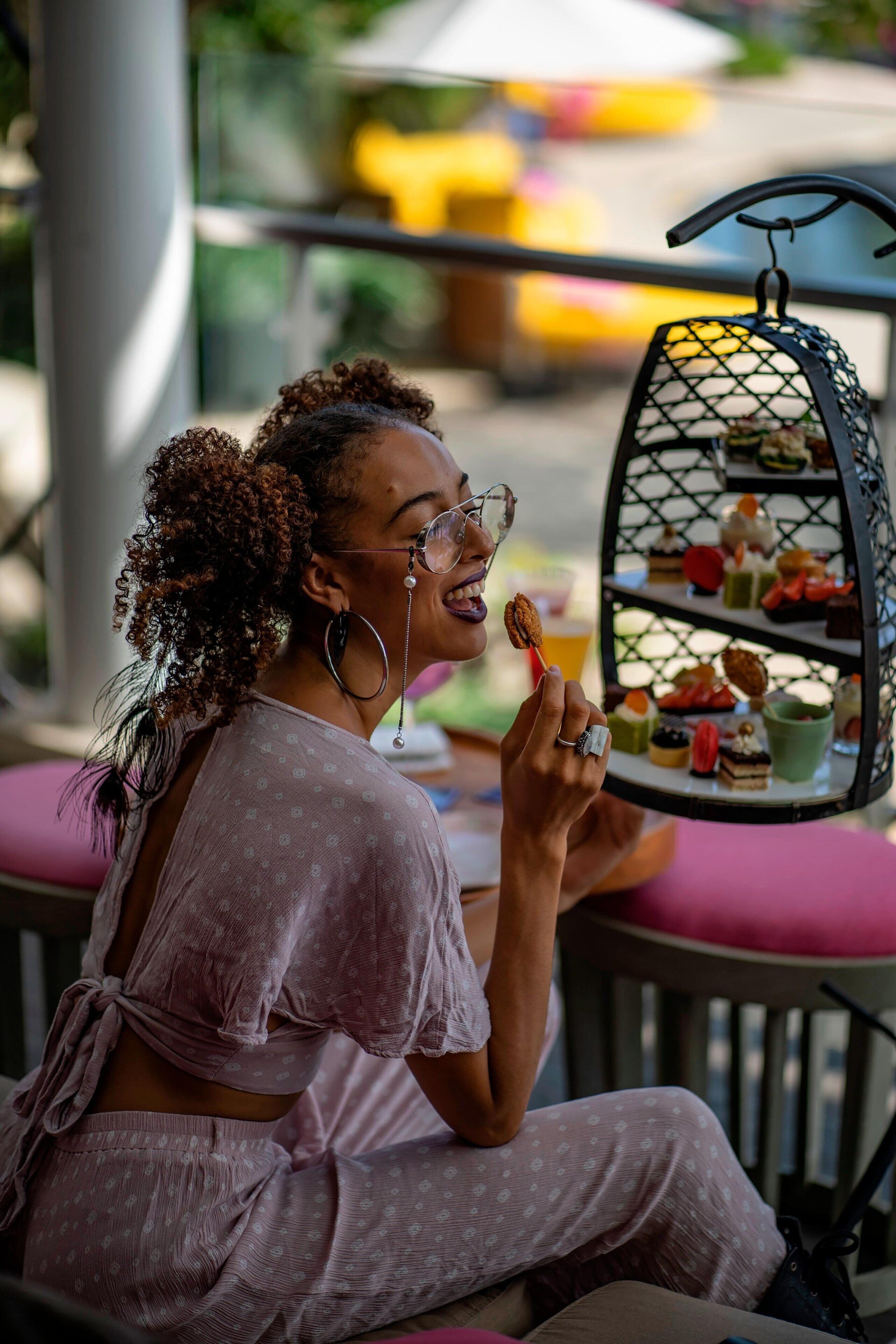 A person seated at a table with a dessert trolley in front of them.