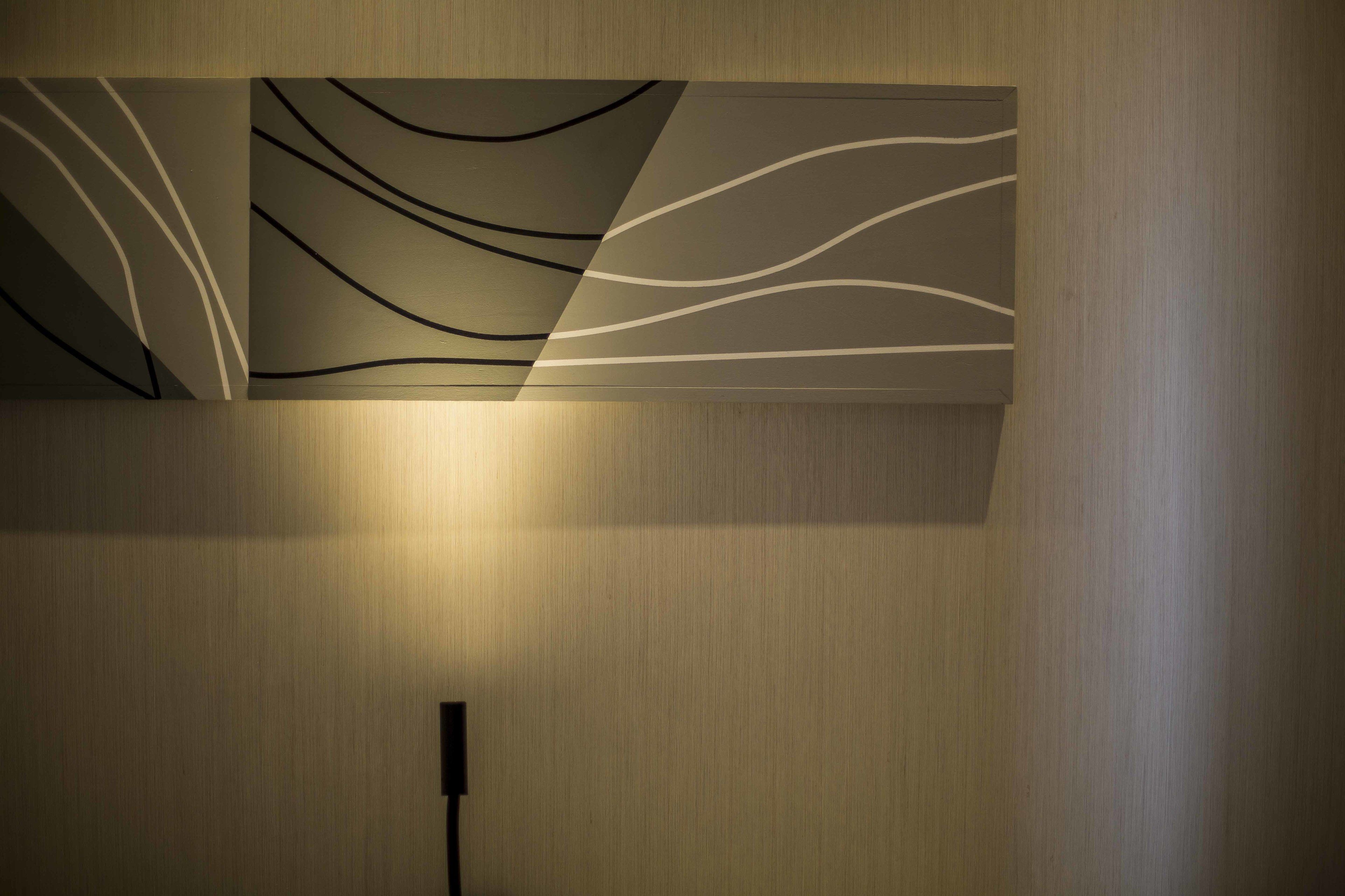 A wall with a modern design featuring abstract wave patterns.