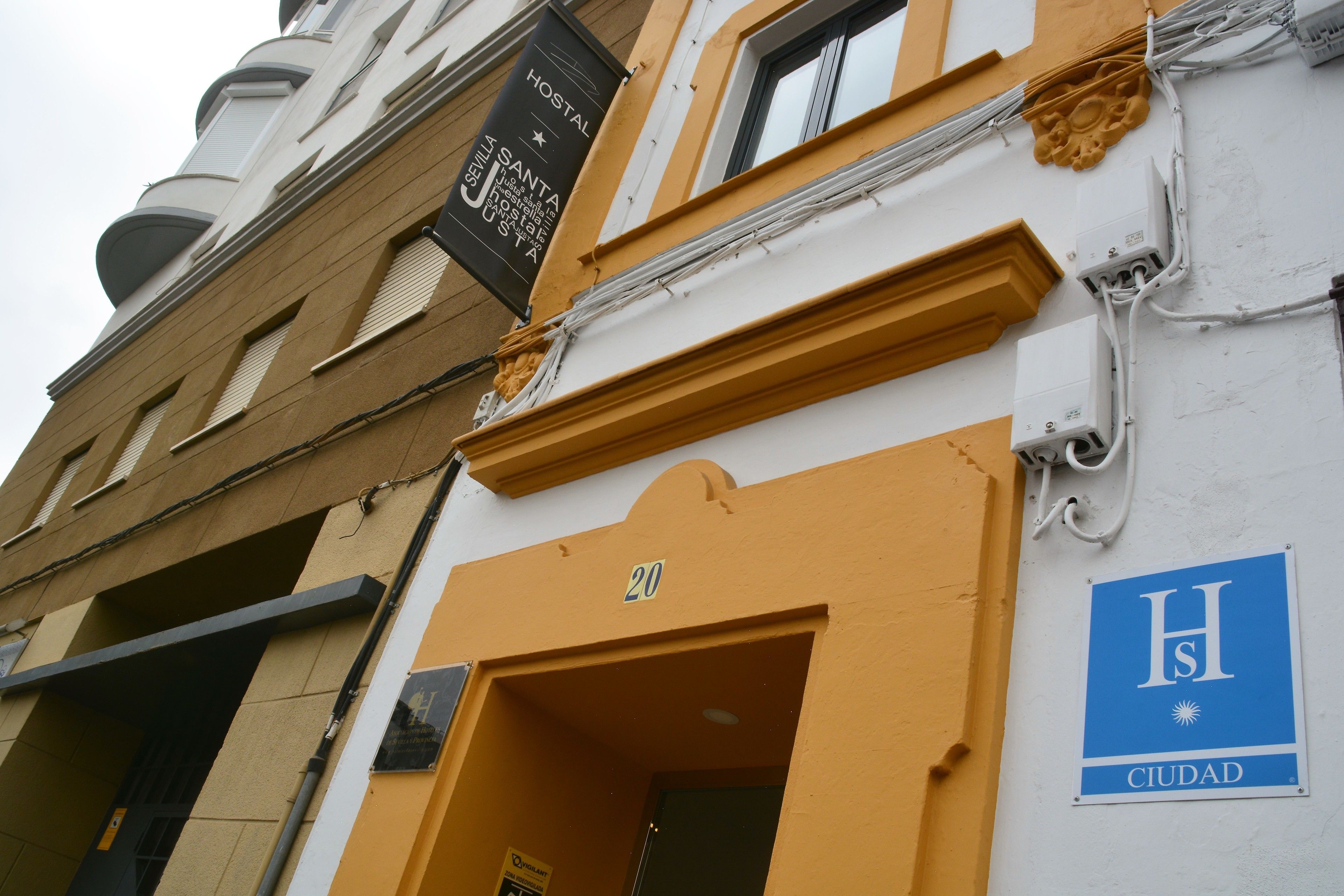 A building with a sign indicating it is a hostel.