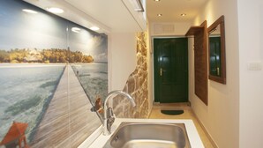 A bathroom with a large mirror, a sink, and a green door. - House Sandra (Split)
