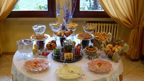 A buffet table with various food items and condiments.