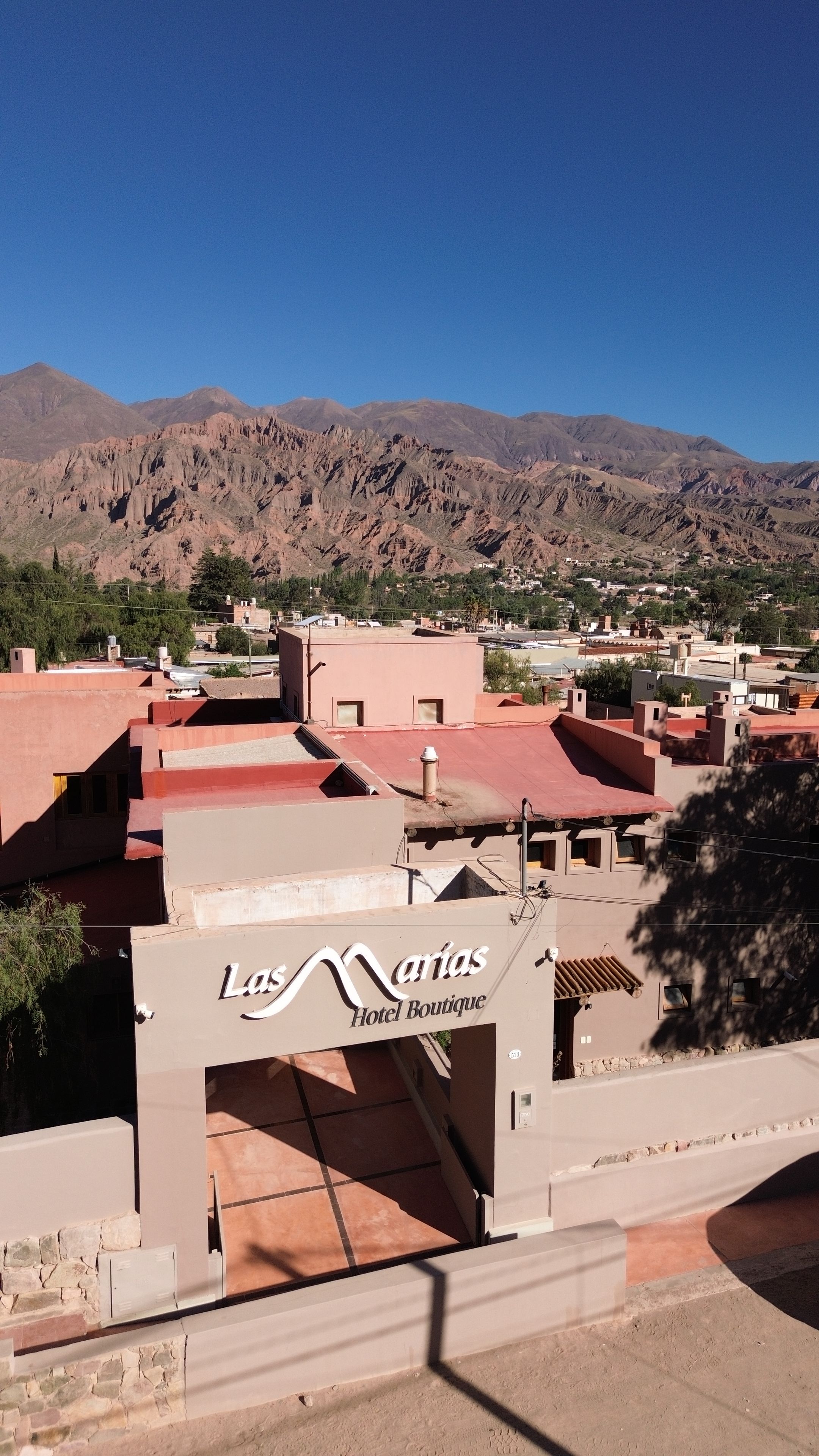 A hotel named 'Las Marias Hotel Boutique' with a view of mountains in the background.