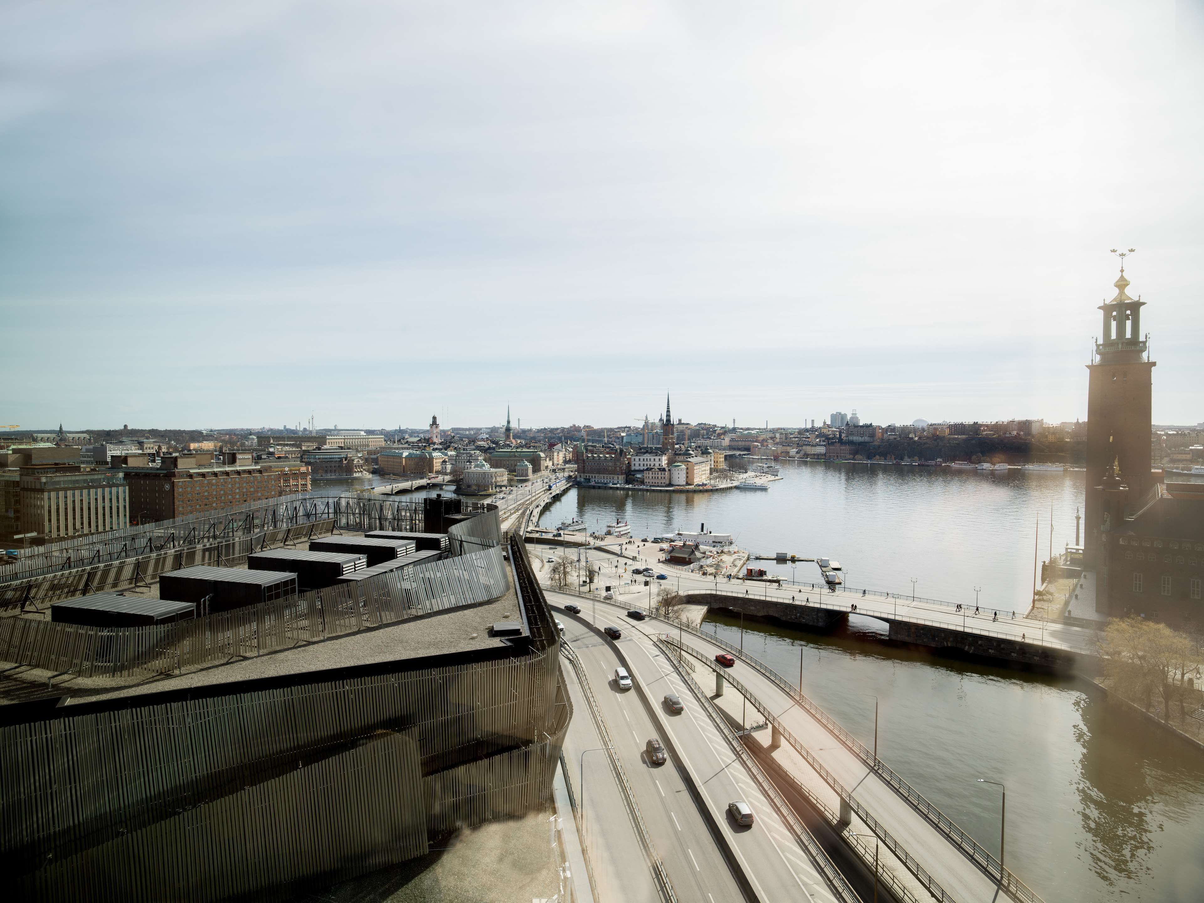 A cityscape with a river, a bridge, and a prominent tower.