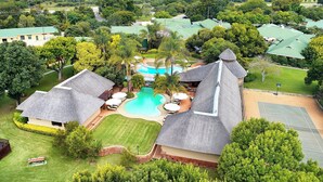 A resort with multiple buildings, a swimming pool, and tennis courts. - Protea Hotel by Marriott Polokwane Ranch Resort (Polokwane)