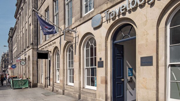 A Travelodge building with a classic architectural style, featuring arched windows and a prominent entrance. - Travelodge Edinburgh Central Waterloo Place (Edinburgh)