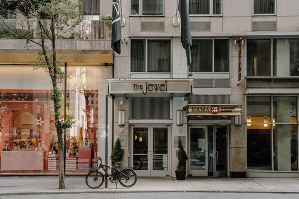 A building with a sign reading "The Jewel" and a restaurant named "HAMA JAPANESE" on the ground floor.