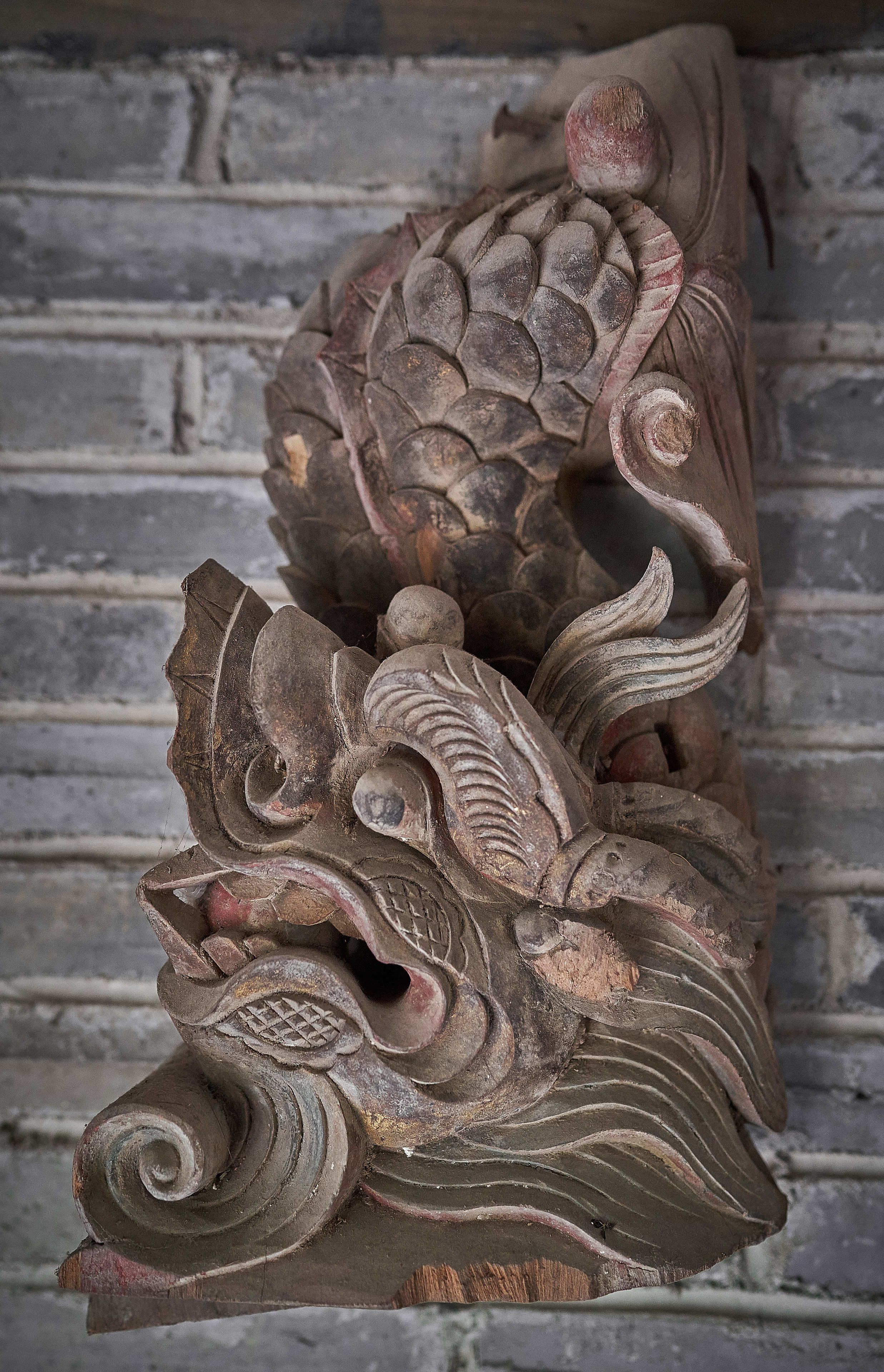 A carved wooden sculpture with intricate patterns and designs.