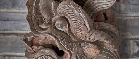 A carved wooden sculpture with intricate patterns and designs.