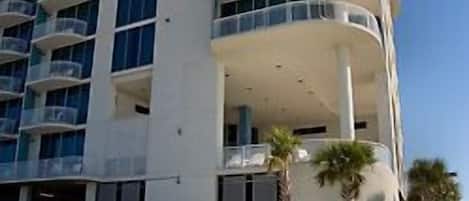 A multi-story hotel with a pool area.
