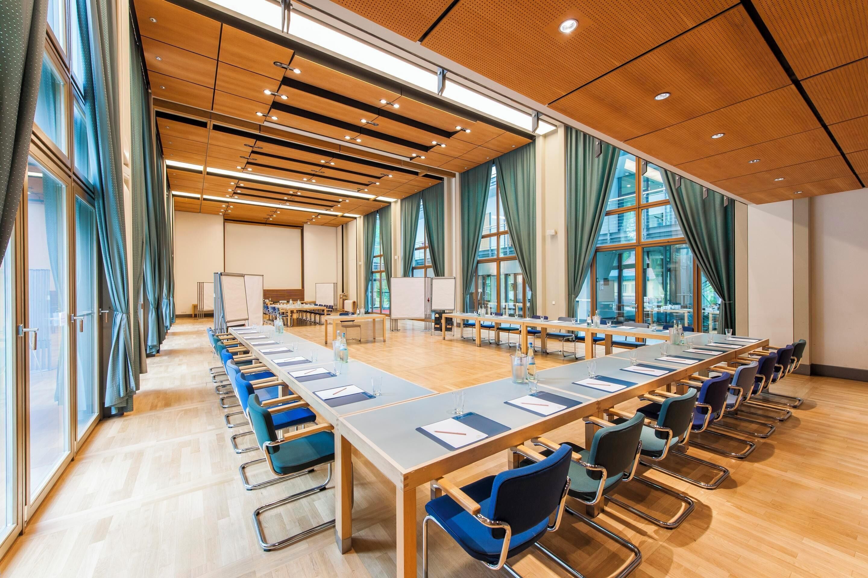 A conference room with a long table, chairs, and a whiteboard.