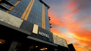 A hotel with a modern glass facade and a prominent 'HOTEL' sign. - The B Hotel (Muntinlupa)
