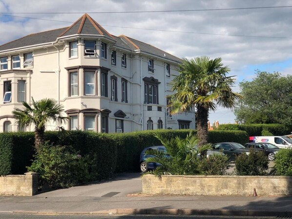 A large, two-story building with a prominent bay window and a corner turret. - The Kensington Hotel (Bournemouth)