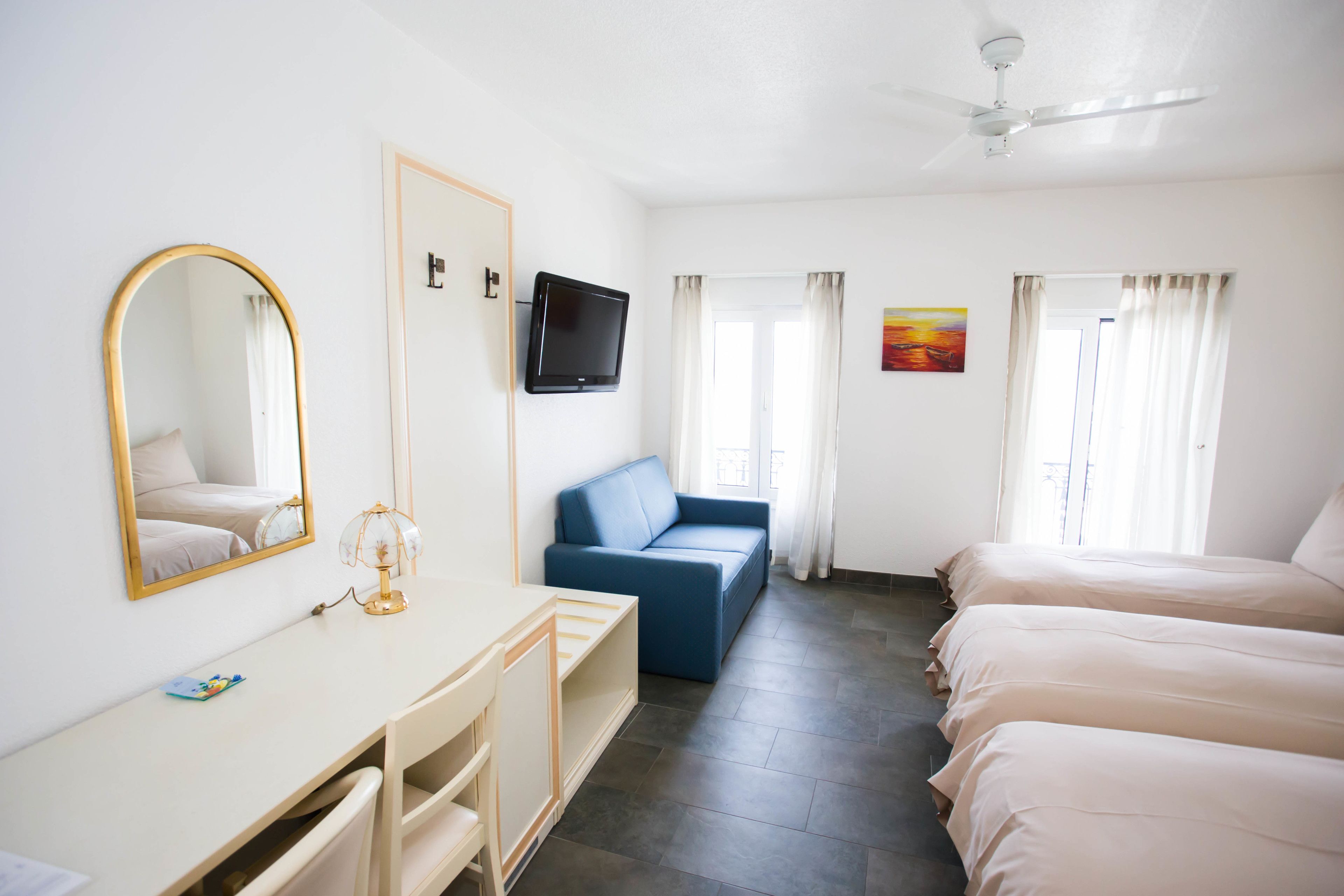 superior triple room, lake view | 1 bedroom, in-room safe, desk, laptop workspace