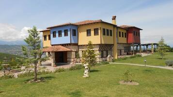 A multi-story building with a stone foundation and colorful upper sections.