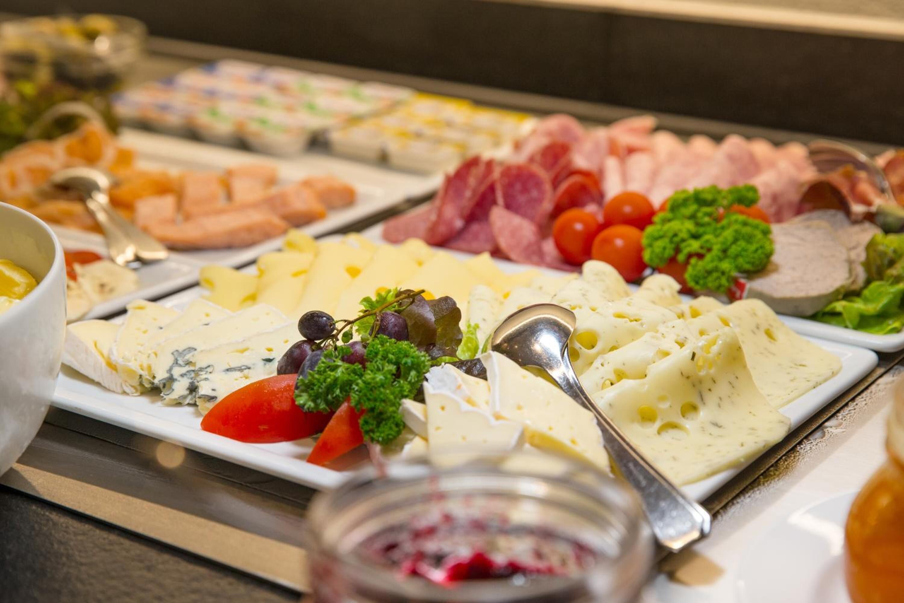 Ein reichhaltiges Buffet mit Käse, Fleisch und Gemüse.