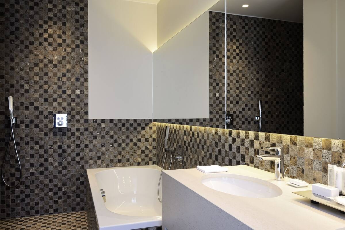 deluxe double room single use | bathroom | hair dryer, slippers, towels