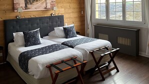 A bedroom with a large bed, a headboard, a window with curtains, and a painting on the wall. - La Bonbonniere, Sure Hotel Collection by Best Western (Talant)