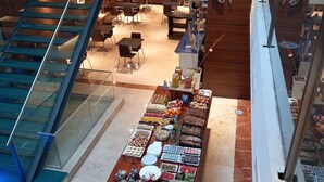 A food display area with various food items and a staircase leading to an upper level.