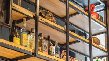 A shelf with various items including a basketball, a baseball glove, and bottles.