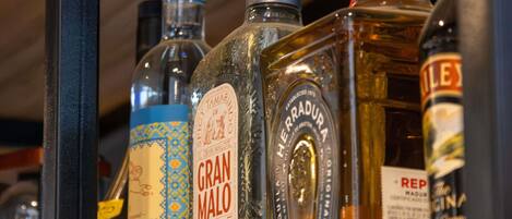 A variety of liquor bottles displayed on a shelf.