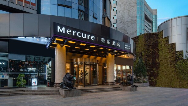 The exterior of the Mercure hotel with a modern facade, large glass windows, and a prominent entrance with a sign. - Mercure Xi'an High-tech Zone Center (Xi'an)