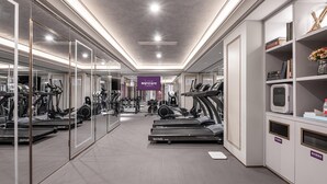 A gym with treadmills, weights, and exercise machines, a mirrored wall, and a sign for Mercure Hotels. - Mercure Xi'an High-tech Zone Center (Xi'an)