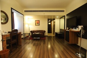 Relax in a stylish room with a leather sofa, flat-screen TV, and kitchenette area.