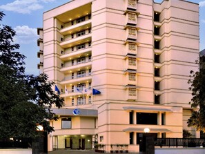 A multi-story hotel with a beige facade, multiple balconies, and a prominent entrance with a sign. - Fortune Inn Haveli, Gandhinagar - Member ITC Hotels' Group (Gandhinagar)