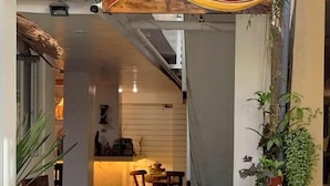 A narrow alleyway leading to a restaurant named 'Bella Cava de Boracay' with a sign indicating a foot washing station.
