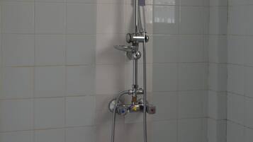 A shower with a square head, a handheld showerhead, and a handheld hose.