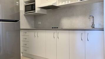 Deluxe Apartment, 2 Bedrooms | Private kitchen | Fridge, microwave, coffee/tea maker, electric kettle