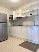 Deluxe Apartment, 2 Bedrooms | Private kitchen | Fridge, microwave, coffee/tea maker, electric kettle