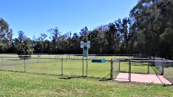 A fenced area with a sign reading "Small Dog Park" and a blue play structure.